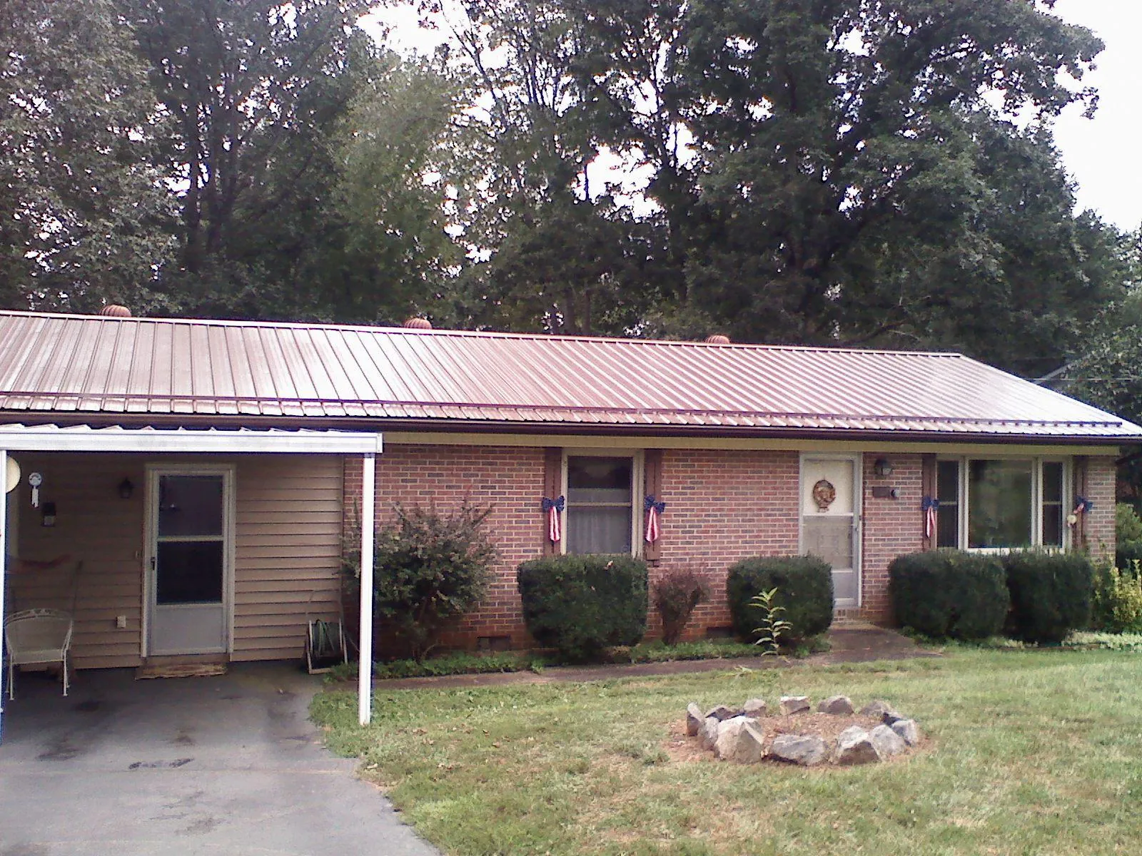 Bronze metal roof and carport on a brick ranch home — Roof Repair work by our crew in Oak Hall