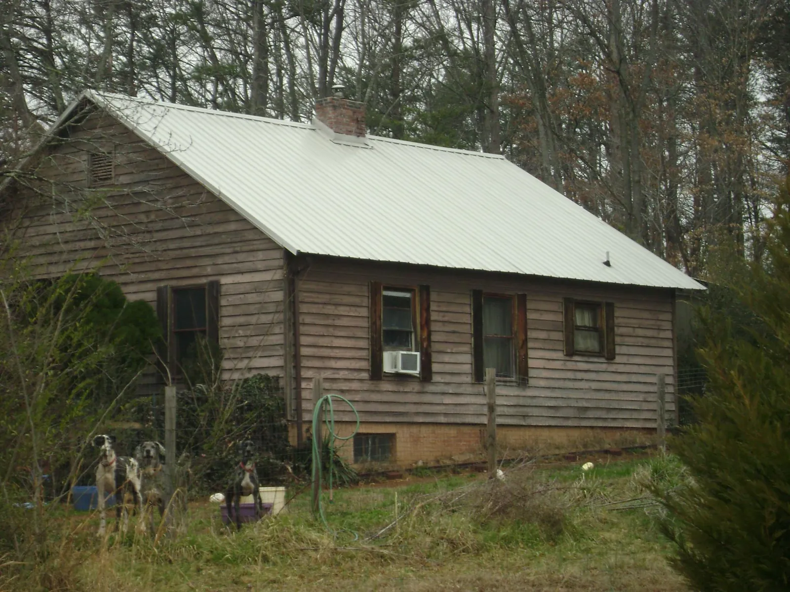 White metal roof on an old wood sided farmhouse, from a Metal Roof Installation job in Oak Hall
